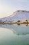 White travertine limestone mountain and its reflection in the la