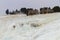 White travertine limestone mountain and terraces with ruins of H