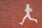 White treadmill symbol on orange asphalt for running, walking or jogging. Running area in the park. Runner track with copy space.