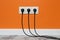 White triple outlet on orange wall