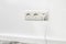 White triple outlet on white wall