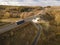 White Truck with Cargo Semi Trailer Moving on Highway Road intersection junction. Aerial Top View