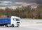 White truck with cargo on the turn on the track