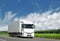 White truck on country highway under blue sky