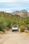 White truck in the hills of arizona on hiking or walking trail with mountain background and natural vegetation