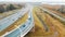 White truck rides on the highway among the flow of cars, aerial view