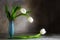 White tulips and a blue porcelain vase on an old wooden table ag