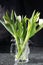 White tulips in a glass mug splashed with water