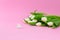 White tulips and heart shaped stone on the pink background. Side view. Horizontal Valentines background or abstract love concept
