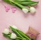 White tulips, hearts and gift box on rosy background. Happy moth