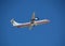 White turboprop airplane taking off against blue sky