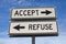 White two street signs with arrow on metal pole with word accept and refuse