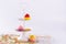 White two tier serving tray and miniature multicolored sugar cupcakes