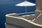 White umbrella on balcony resort house and Aegean sea, Santorini, Greece