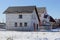 White unfinished brick house on a building site in the snow