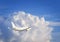 White unmarked passenger jet plane on the background of beautiful clouds. Vacation and travel concept. Airplane in the beautiful