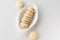 White vanilla macaroons on wooden background. Delicious Argentinian cookies alfajores with cream on plate. Top view.