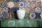 White vase on the fireplace shelf , bright tile, decorated wall