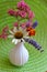 White Vase on green mat with Marigold, Valerian, Lavender, White Coneflower