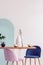 White vase on wooden table with fancy dining room interior with white and blue wall