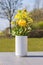 White vase with yellow wildflowers