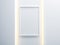 White vertical Poster canvas with Frame Mockup hanging on the wall with ambient light illumination