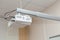 The white video projector is suspended from an adjustable ceiling bracket.