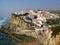 White village perched on a rock on the sea in Portugal.