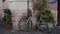 White vintage bicycle parked against wall of ancient European house, Rome, Italy