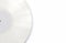 White Vinyl Record with a Empty Label on a White Surface. Minimalist Music Background with Copy Space.