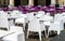 White and violet chairs and tables in cafe