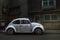 White Volkswagen Beetle parked in the middle of the city