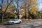 A white Volvo V90 inscription station wagon parked on a community street in Wilmington, Delaware in autumn