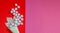 White waffle cone with white decorative christmas maple leaf and soft snowflakes balls on the red pink background. Modern design