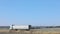 A white wagon drives along the highway in sunny weather. Truck on the highway