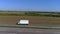 A white wagon drives along the highway in sunny weather. Truck on the highway