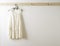 White wall and clothes on a hanger.