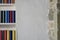 White wall in a loft with part of bookshelf and stone wall