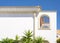 White wall with roof, drainpipe and niche outdoors in Greece