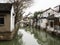 White walled houses reflected in canal waters in historic downtown Suzhou