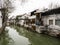 White walled houses reflected in canal waters in historic downtown Suzhou