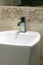 White washbasin and chrome tap