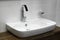 White washbasin and chrome tap