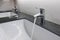 White washbasins and faucet on granite counter