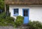 White-washed, stone cottage with thatched roof, Cadgwith, Cornwall, England