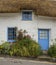 White-washed, stone cottage with thatched roof, Cadgwith, Cornwall, England