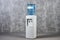 White water cooler gallon in office against gray textured wall b