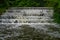 White Water flowing over weir low level view at long exposure