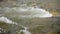 White water forming over rocks in spring river - slow motion video