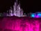 White water fountain and multi-colored lighted icicle walls in ice castle